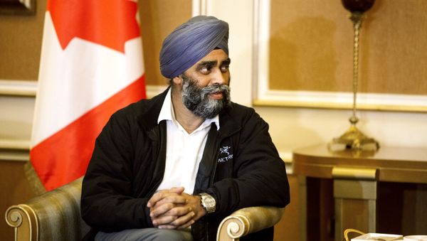 Harjit Sajjan, Canadian Defense Minister, is welcomed by Karim Sinjari, Interior Minister of the Kurdish Regional Government (KRG), not pictured, upon his arrival to Irbil, northern Iraq, Sunday, Dec. 20, 2015 - Sputnik International