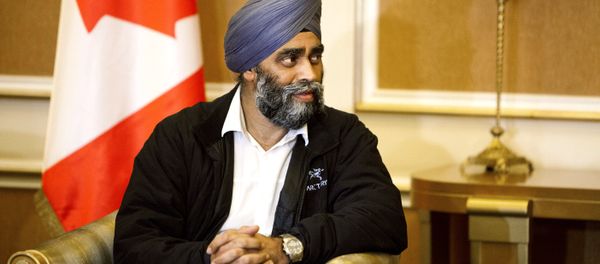 Harjit Sajjan, Canadian Defense Minister, is welcomed by Karim Sinjari, Interior Minister of the Kurdish Regional Government (KRG), not pictured, upon his arrival to Irbil, northern Iraq, Sunday, Dec. 20, 2015 - Sputnik International