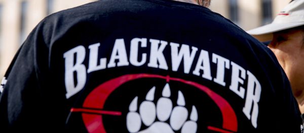 A former member of Blackwater joines family members, friends, and supporters of four former Blackwater security guards outside the federal court in Washington, Monday, April 13, 2015 - Sputnik International