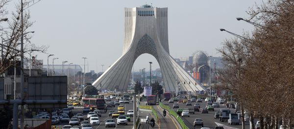A picture taken on January 18, 2016 shows vehicles driving on a street in front of the Azadi Tower in the capital Tehran A picture taken on January 18, 2016 shows vehicles driving on a street in front of the Azadi Tower in the capital Tehran - Sputnik International