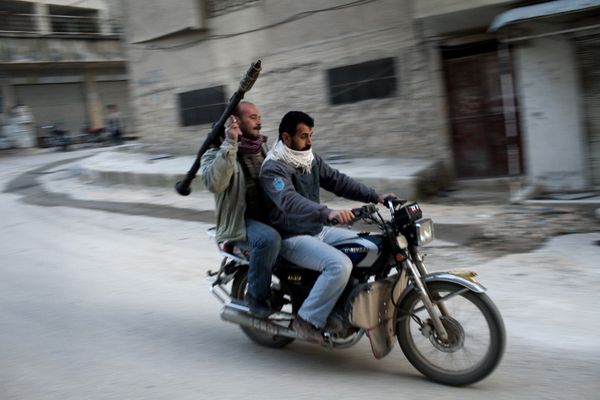 Supporters of the Free Syrian Army ride a motorcycle with a rocket-propelled grenade in Kafar Taharim, Syria. - Sputnik International
