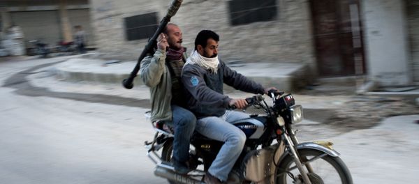 Supporters of the Free Syrian Army ride a motorcycle with a rocket-propelled grenade in Kafar Taharim, Syria. Supporters of the Free Syrian Army ride a motorcycle with a rocket-propelled grenade in Kafar Taharim, Syria. - Sputnik International