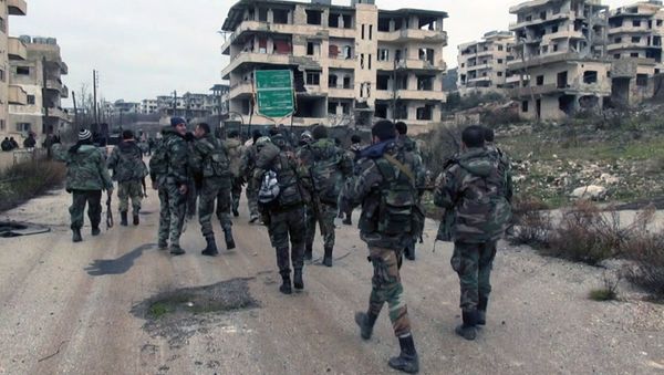 Syrian government troops and allied militiamen walk inside the key town of Salma in Latakia province, Syria. - Sputnik International