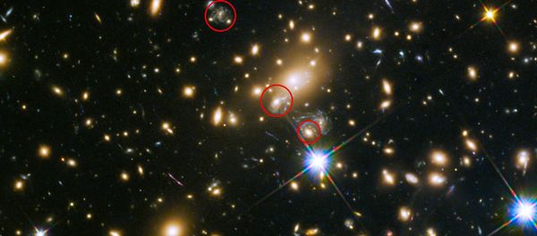 This image shows the appearances of the Refsdal supernova. The uppermost circle shows the position of the supernova as it could have been seen in 1998. The lowermost circle shows the galaxy which lensed the supernova four time — a discovery made in late 2014. The middle circle shows the latest position of the reappearing supernova in 2015. This image shows the appearances of the Refsdal supernova. The uppermost circle shows the position of the supernova as it could have been seen in 1998. The lowermost circle shows the galaxy which lensed the supernova four time — a discovery made in late 2014. The middle circle shows the latest position of the reappearing supernova in 2015. - Sputnik International