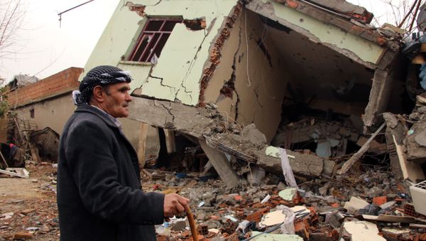 A resident walks on the rubble of a destroyed house in the mostly-Kurdish town of Silopi, in southeastern Turkey. - Sputnik International