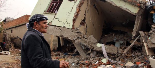 A resident walks on the rubble of a destroyed house in the mostly-Kurdish town of Silopi, in southeastern Turkey. - Sputnik International