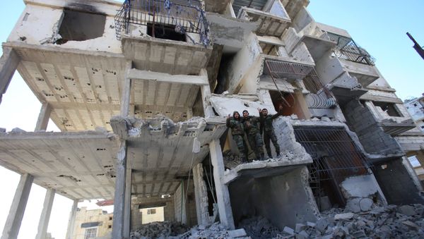 Members of the Syrian pro-government forces pose for a picture in a destroyed building in the strategic town of Salma, in the coastal Latakia province, on January 15, 2016, following its recapture from militants Members of the Syrian pro-government forces pose for a picture in a destroyed building in the strategic town of Salma, in the coastal Latakia province, on January 15, 2016, following its recapture from militants - Sputnik International