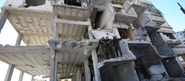 Members of the Syrian pro-government forces pose for a picture in a destroyed building in the strategic town of Salma, in the coastal Latakia province, on January 15, 2016, following its recapture from militants Members of the Syrian pro-government forces pose for a picture in a destroyed building in the strategic town of Salma, in the coastal Latakia province, on January 15, 2016, following its recapture from militants - Sputnik International