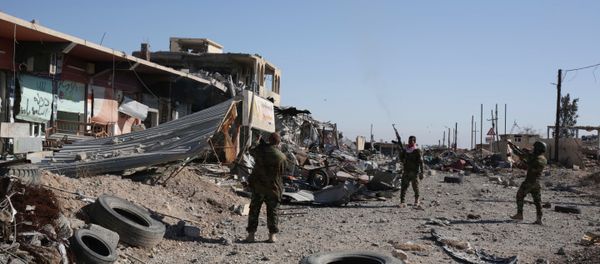 Kurdish peshmerga fighters fire into the the air while celebrating the retaking of of Sinjar, northern Iraq, Friday Nov. 13, 2015 - Sputnik International