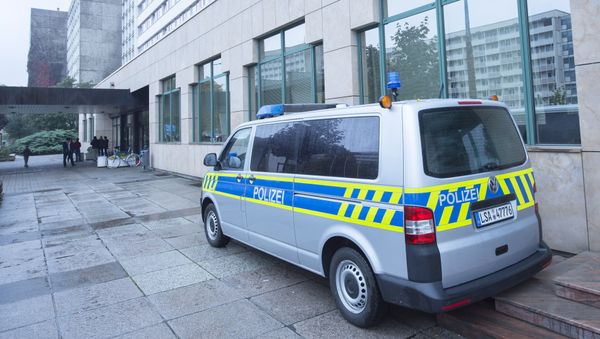 A police car stands in front of the initial reception center for asylum seekers in Halle/Saale, Germany, Friday, Oct. 16, 2015 - Sputnik International