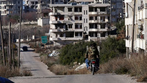 Syrian army soldiers ride a motorcycle in the village of Salma, in the northwestern province of Latakia on January 15, 2016 - Sputnik International