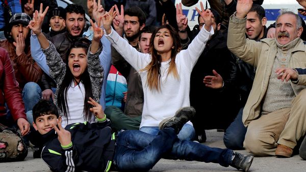 Kurdish demonstrators shout slogans during a protest against a curfew in Sur district and security operations in the region, in the southeastern city of Diyarbakir, Turkey January 17, 2016. Kurdish demonstrators shout slogans during a protest against a curfew in Sur district and security operations in the region, in the southeastern city of Diyarbakir, Turkey January 17, 2016. - Sputnik International