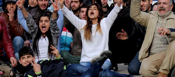 Kurdish demonstrators shout slogans during a protest against a curfew in Sur district and security operations in the region, in the southeastern city of Diyarbakir, Turkey January 17, 2016. Kurdish demonstrators shout slogans during a protest against a curfew in Sur district and security operations in the region, in the southeastern city of Diyarbakir, Turkey January 17, 2016. - Sputnik International