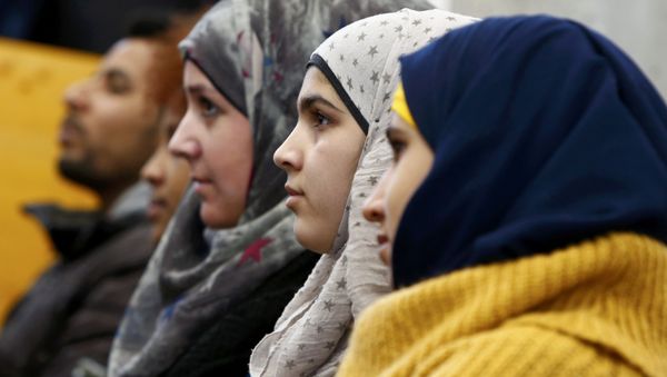 Migrants aged between 16 and 21 years, coming from different countries, attend a lesson on basics in law by Bavarian Justice Minister Winfried Bausback (unseen) at a trade school in Ansbach, Germany, January 11, 2016. REUTERS/Michaela Rehle - Sputnik International