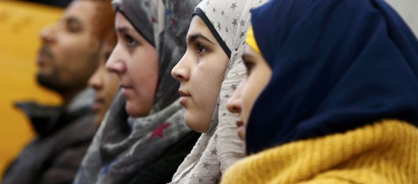 Migrants aged between 16 and 21 years, coming from different countries, attend a lesson on basics in law by Bavarian Justice Minister Winfried Bausback (unseen) at a trade school in Ansbach, Germany, January 11, 2016. REUTERS/Michaela Rehle - Sputnik International