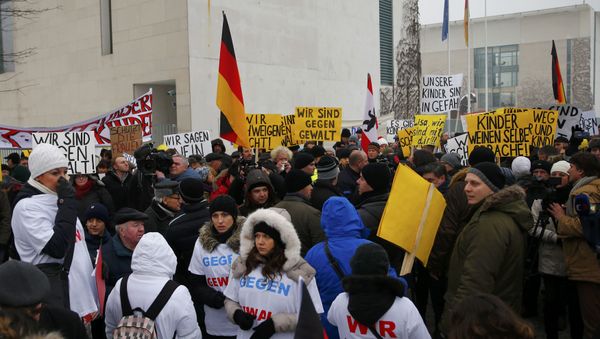 Activists and supporters of the 'International Convention of German Russians' protest against sexual harassment by migrants in front of the Chancellery in Berlin, Germany Activists and supporters of the 'International Convention of German Russians' protest against sexual harassment by migrants in front of the Chancellery in Berlin, Germany - Sputnik International