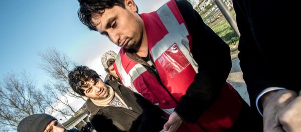 A translator shows documents to Afghan migrants during a roam by members of The French Office for the Protection of Refugees and Stateless Persons (OFPRA), at the Jules Ferry reception centre near the Jungle migrant camp in Calais, on January 14, 2016. A translator shows documents to Afghan migrants during a roam by members of The French Office for the Protection of Refugees and Stateless Persons (OFPRA), at the Jules Ferry reception centre near the Jungle migrant camp in Calais, on January 14, 2016. - Sputnik International