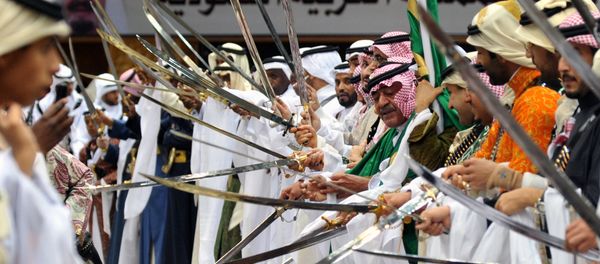 Saudi second deputy Prime Minister Mugren bin Abdulaziz (C-R) and unidentified Emirs perform during the traditional Saudi dancing best known as 'Arda' which performed during the Janadriya culture festival at Der'iya in Riyadh - Sputnik International