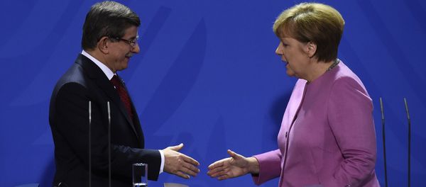 German Chancellor Angela Merkel (R) and Turkish Prime Minister Ahmet Davutoglu (L) shake hands during the press conference, after a meeting at the Chancellery, in Berlin on January 22, 2016 German Chancellor Angela Merkel (R) and Turkish Prime Minister Ahmet Davutoglu (L) shake hands during the press conference, after a meeting at the Chancellery, in Berlin on January 22, 2016 - Sputnik International