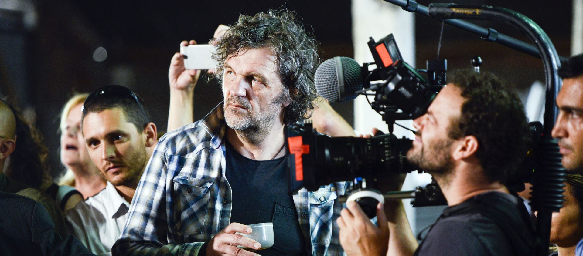 Serbian filmmaker Emir Kusturica, center, stands next to a cameraman while documenting the inauguration of an agricultural trade school that borders the family farm of former President Jose Mujica, on the outskirts of Montevideo, Uruguay, Thursday, March 5, 2015 Serbian filmmaker Emir Kusturica, center, stands next to a cameraman while documenting the inauguration of an agricultural trade school that borders the family farm of former President Jose Mujica, on the outskirts of Montevideo, Uruguay, Thursday, March 5, 2015 - Sputnik International, 1920, 16.01.2020
