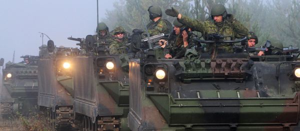 Soldiers ride in tanks during the multinational military exercise for Lithuanian, Polish and Ukrainian troops, Maple Arch 2012, at Pabrade Training Area in Lithuania's Svencionys district, near Vilnius, on September 21, 2012 - Sputnik International