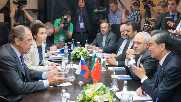 Minister of Foreign Affairs of the Russian Federation Sergei Lavrov, left, Minister of Foreign Affairs of the People's Republic of China Wang Yi, right, and Minister of Foreign Affairs of the Islamic Republic of Iran Mohammad Javad Zarif, second right, during a trilateral meeting as part of the High-Level Conference on Security and Stability in the SCO Region Minister of Foreign Affairs of the Russian Federation Sergei Lavrov, left, Minister of Foreign Affairs of the People's Republic of China Wang Yi, right, and Minister of Foreign Affairs of the Islamic Republic of Iran Mohammad Javad Zarif, second right, during a trilateral meeting as part of the High-Level Conference on Security and Stability in the SCO Region - Sputnik International