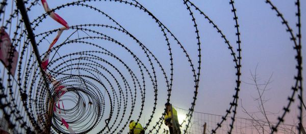 Workers take measurements of a near finished section of a 3,7 km long fence at a border crossing between Austria and Slovenia at Spielfeld, Austria on December 9, 2015. Workers take measurements of a near finished section of a 3,7 km long fence at a border crossing between Austria and Slovenia at Spielfeld, Austria on December 9, 2015. - Sputnik International