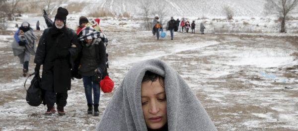 Migrants walk through a frozen field after crossing the border from Macedonia, near the village of Miratovac, Serbia, January 18, 2016. Migrants walk through a frozen field after crossing the border from Macedonia, near the village of Miratovac, Serbia, January 18, 2016. - Sputnik International