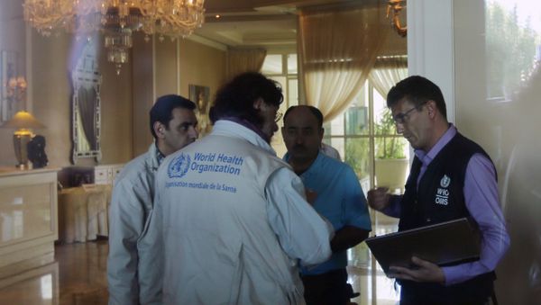 Representatives of the World Health Organization (WHO) talk in the hall of an hotel September 26, 2013 in the Syrian capital Damascus - Sputnik International