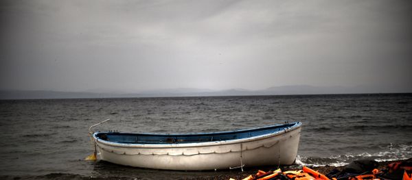 Life jackets and a boat that were used by refugees and migrants to cross the Aegean sea from Turkey lie abandoned on a beach on the Greek Island of Lesbos on October 8, 2015. Life jackets and a boat that were used by refugees and migrants to cross the Aegean sea from Turkey lie abandoned on a beach on the Greek Island of Lesbos on October 8, 2015. - Sputnik International