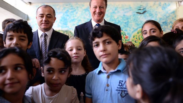 Prime Minister David Cameron (C back) and Lebanese Education Minister Elias Bou Saab (back L) visit the Sad al-Bouchrieh School in Beirut on September 14, 2015. Prime Minister David Cameron (C back) and Lebanese Education Minister Elias Bou Saab (back L) visit the Sad al-Bouchrieh School in Beirut on September 14, 2015. - Sputnik International