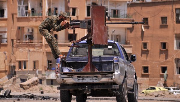 A member of the Kurdish People's Protection Units (YPG) mans a mounted machine gun in the Al-Nashwa neighbourhood in the northeastern Syrian province of Hasakeh on July 26, 2015 A member of the Kurdish People's Protection Units (YPG) mans a mounted machine gun in the Al-Nashwa neighbourhood in the northeastern Syrian province of Hasakeh on July 26, 2015 - Sputnik International
