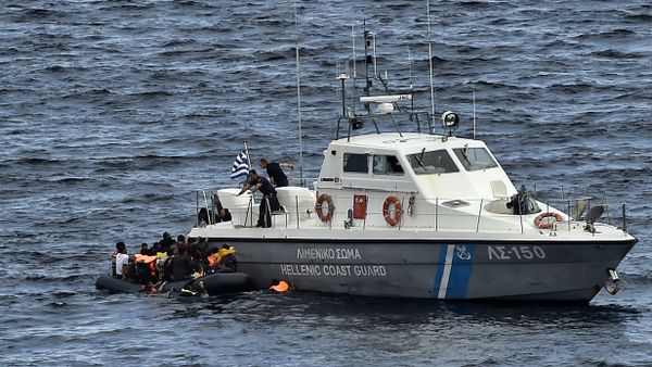 Hellenic coast guard personnel rescue refugees and migrants on a dinghy as they try to reach the Greek island of Lesbos while crossing the Aegean sea from Turkey on September 29, 2015 Hellenic coast guard personnel rescue refugees and migrants on a dinghy as they try to reach the Greek island of Lesbos while crossing the Aegean sea from Turkey on September 29, 2015 - Sputnik International