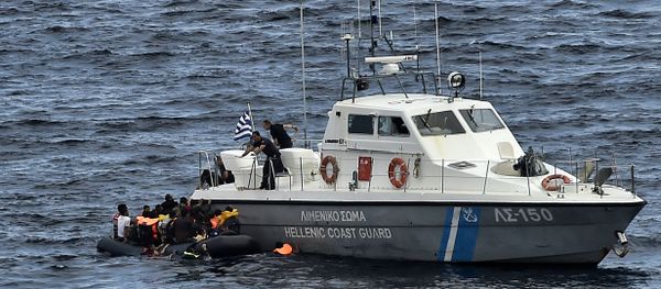 Hellenic coast guard personnel rescue refugees and migrants on a dinghy as they try to reach the Greek island of Lesbos while crossing the Aegean sea from Turkey on September 29, 2015 Hellenic coast guard personnel rescue refugees and migrants on a dinghy as they try to reach the Greek island of Lesbos while crossing the Aegean sea from Turkey on September 29, 2015 - Sputnik International