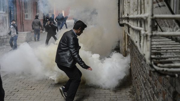 People react as tear gas is sprayed during clashes with Turkish police at the Sur district in Diyarbakir, on January 3, 2016 People react as tear gas is sprayed during clashes with Turkish police at the Sur district in Diyarbakir, on January 3, 2016 - Sputnik International