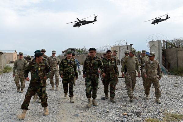  US army and Afghan National Army (ANA) soldiers walk as a NATO helicopter flies overhead  - Sputnik International