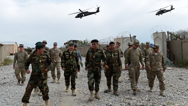 US army and Afghan National Army (ANA) soldiers walk as a NATO helicopter flies overhead US army and Afghan National Army (ANA) soldiers walk as a NATO helicopter flies overhead - Sputnik International