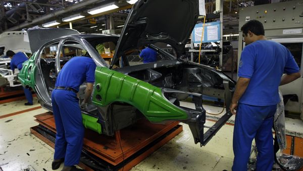 An Iranian man works on a Peugeot 206 car at the Iran Khodro auto plant, west of Tehran (File) - Sputnik International