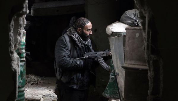 A fighter from the Jaish al-Islam (Islam Army), the foremost rebel group in Damascus province guards a position on the front line in Jobar, on the eastern edge of the Syrian capital - Sputnik International