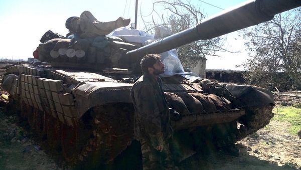 Syrian Arab Army soldier stands near a T72 tank in the town of Al-Shaykh Maskin in the Daraa province liberated from terrorists Syrian Arab Army soldier stands near a T72 tank in the town of Al-Shaykh Maskin in the Daraa province liberated from terrorists - Sputnik International