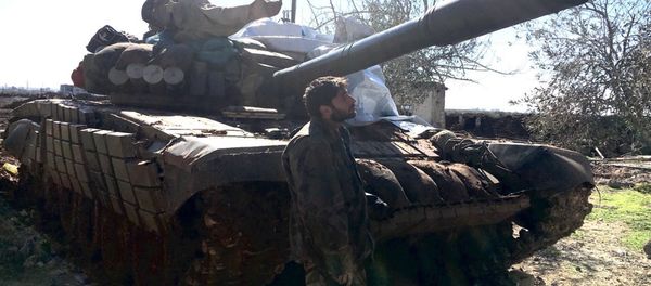 Syrian Arab Army soldier stands near a T72 tank in the town of Al-Shaykh Maskin in the Daraa province liberated from terrorists Syrian Arab Army soldier stands near a T72 tank in the town of Al-Shaykh Maskin in the Daraa province liberated from terrorists - Sputnik International