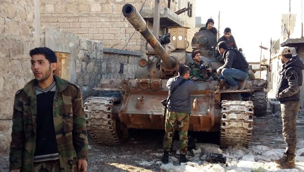 Government forces chat near a tank three kilometres from the Shiite villages of Nabbul and Zahra in Syria's northern Aleppo province which have been under siege by the Islamic State (IS) group for three years on February 2, 2016 Government forces chat near a tank three kilometres from the Shiite villages of Nabbul and Zahra in Syria's northern Aleppo province which have been under siege by the Islamic State (IS) group for three years on February 2, 2016 - Sputnik International