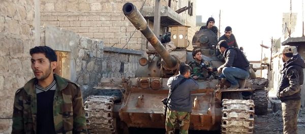 Government forces chat near a tank three kilometres from the Shiite villages of Nabbul and Zahra in Syria's northern Aleppo province which have been under siege by the Islamic State (IS) group for three years on February 2, 2016 Government forces chat near a tank three kilometres from the Shiite villages of Nabbul and Zahra in Syria's northern Aleppo province which have been under siege by the Islamic State (IS) group for three years on February 2, 2016 - Sputnik International