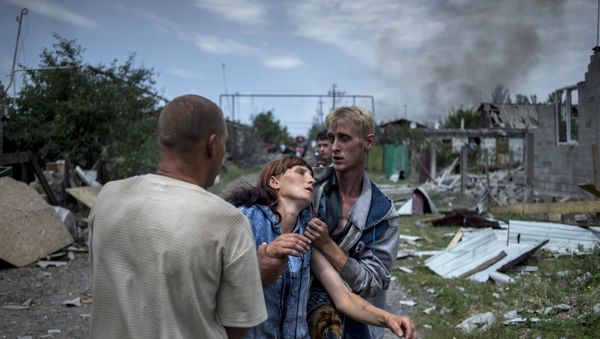 Local residents in the village of Luganskaya after the Ukrainian armed forces' air attack. File photo Local residents in the village of Luganskaya after the Ukrainian armed forces' air attack. File photo - Sputnik International
