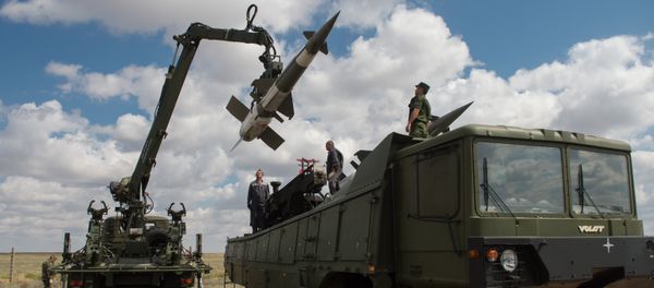 Servicemen load a Pechora-2M air defense complex of the Tajikistan armed forces during the 2013 Combat Commonwealth, a military drill for the CIS joint air defense system, at the Ashuluk training ground Servicemen load a Pechora-2M air defense complex of the Tajikistan armed forces during the 2013 Combat Commonwealth, a military drill for the CIS joint air defense system, at the Ashuluk training ground - Sputnik International