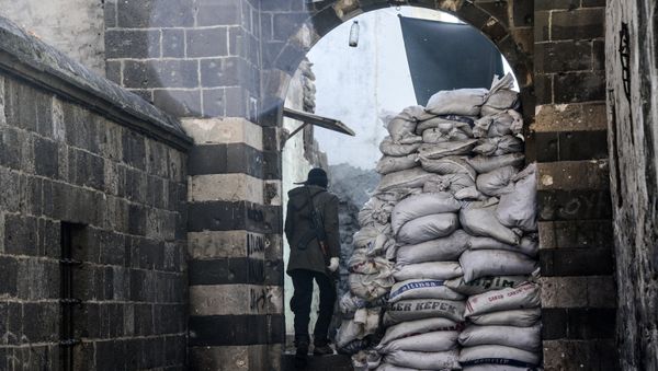 Kurdish fighter walks through barricads in the Sur district in Diyarbakir on December 11, 2015 Kurdish fighter walks through barricads in the Sur district in Diyarbakir on December 11, 2015 - Sputnik International