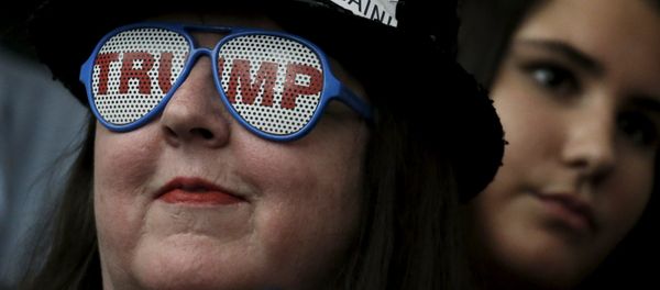 A supporter of Republican presidential candidate Donald Trump wears glasses with the word Trump on it as she listens to Mr Trump's remarks at a campaign rally in Milford, New Hampshire, February 2, 2016 - Sputnik International