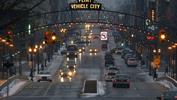 FILE - Vehicles drive through downtown Flint, Mich., on Jan. 21, 2016. From its founding, Flint's fortunes essentially were entwined with a single industry. First it was the fur trade, which shifted to lumber, which gave way to the horse carriages that led to it being called Vehicle City. It was a fitting moniker for its next, most important role, as a powerhouse of auto manufacturing and the original home of General Motors. - Sputnik International