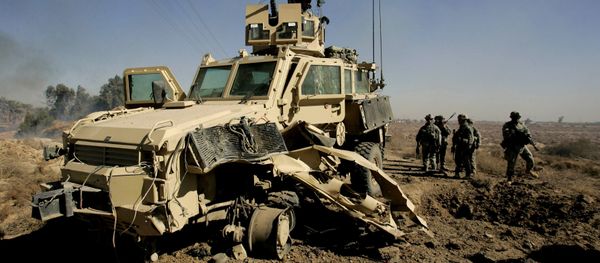 U.S. soldiers secure the area next to a damaged U.S. mine resistant, ambush protected vehicle (MRAP), after a roadside bomb explosion during an operation in the area of Al-leg, some 40 miles south of Baghdad, Iraq (File) - Sputnik International