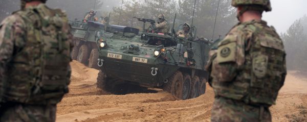 Picture taken on February 26, 2015 shows armored fighting vehicles IAV Stryker of the US Cavalry Regiment 2nd subdivision during training with Latvian an Canadian soldiers at the Adazi military training area in Latvia - Sputnik International